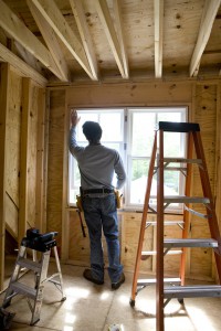 Contractor working on window in new home